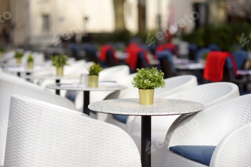 Preview: An empty stylish street cafe in a European city in autumn or winter. Cozy outdoor restaurant.