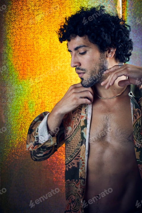 Preview: Studio portrait of mid adult man wearing unbuttoned shirt