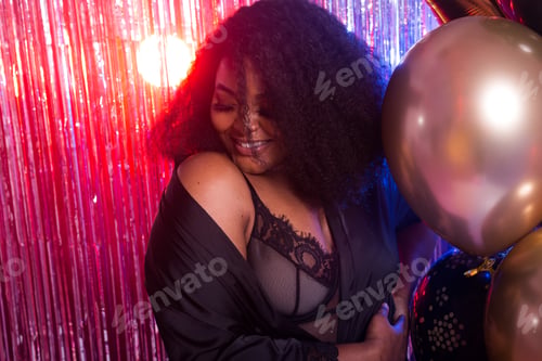 Preview: Beautiful black woman enjoying a party lifestyle. Birthday party, clubbing and holidays concept