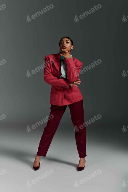 Preview: Stylish young woman showcases fashion versatility in modern studio setting