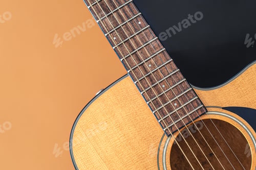Preview: Acoustic guitar close-up on a colored background, flat lay.