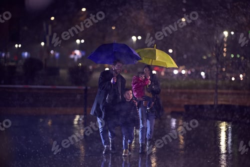 Preview: In the midst of a rainy urban night, a happy couple takes their children on a stroll through the