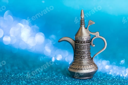 Vista previa: Arabic traditional coffee pot on blue glitter bokeh background