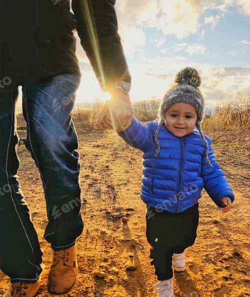 Preview: Toddler and Adult Enjoying Outdoor Walk at Sunset