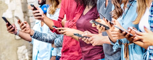 Preview: Cropped view on millenial hands using mobile smart phones