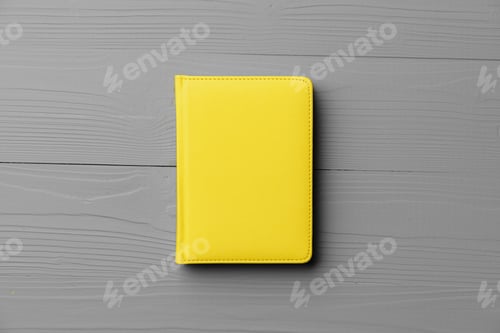Preview: Yellow notepad on gray wooden background top view