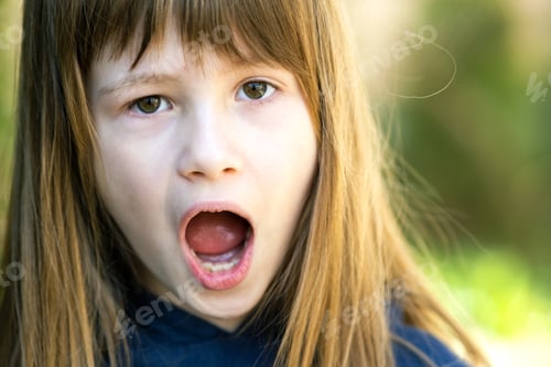 Preview: Portrait of surprised child girl outdoors in summer. Shocked female kid on a warm day outside.