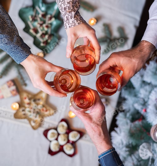 Preview: top view of people holding wine glasses over festive table