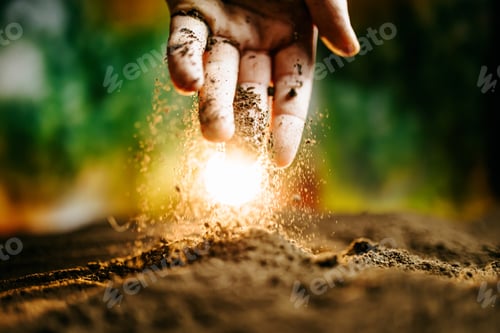 Preview: Man Farmer Hands Touching Ground on Field.