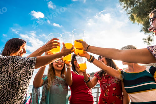 Preview: Team of young women caucasian people celebrate and toast together with orange juice