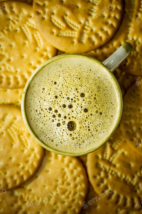 Preview: Overhead shot of a cup of coffee surrounded by cookies