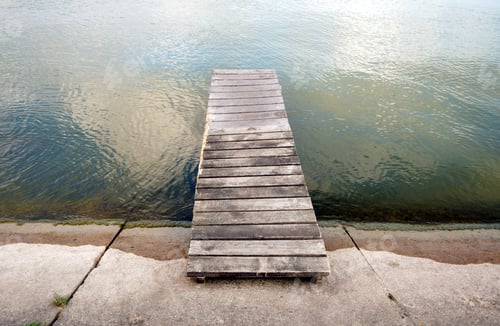 Preview: Small abandoned wooden pier at lake