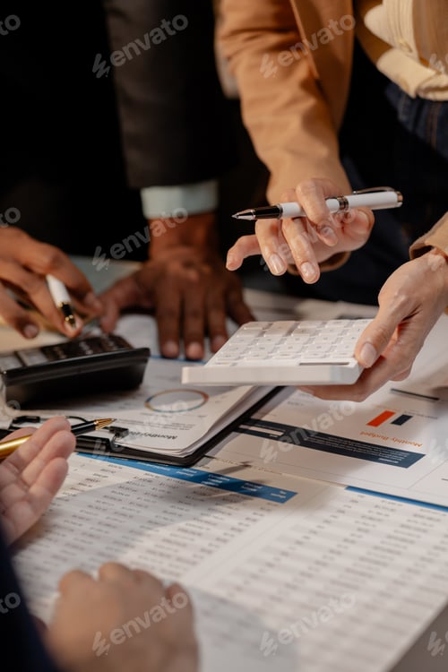 Preview: A group of three businesspeople are working together to calculate the company's numbers, employees a