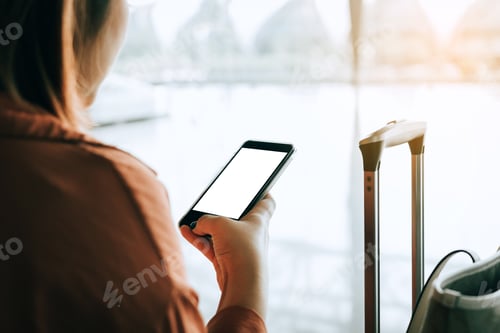 Preview: Asian tourist woman hands holding and using smartphone.