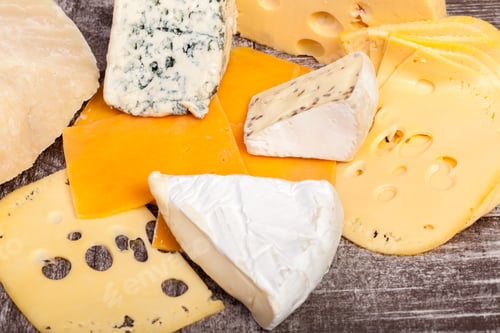 Preview: White cheese and other type of cheese on wooden background