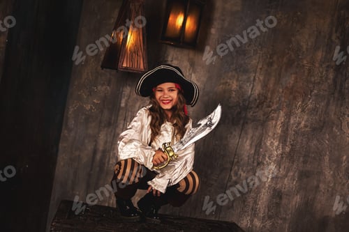 Preview: Joyful pirate posing on chest in underground room or hold of pirates ship