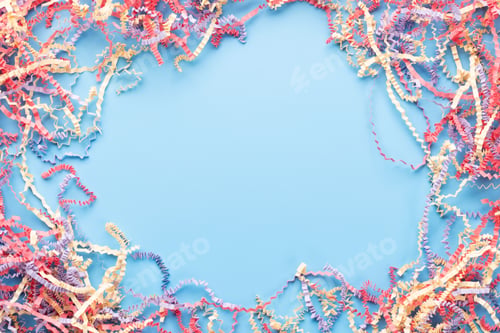 Preview: Colorful tinsel and confetti on blue