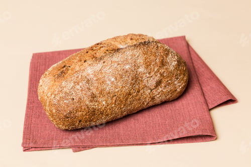 Preview: Assortment of freshly baked bread with napkin on rustic table top view.