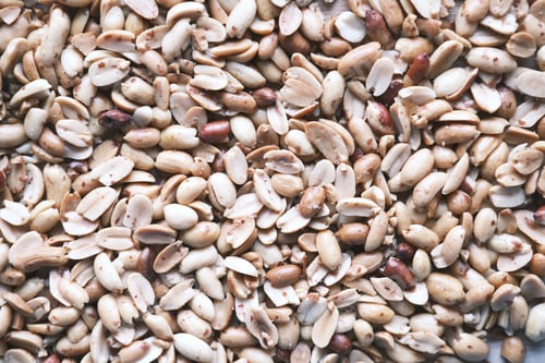 Preview: Processed pea nuts in a bowl on table top down .