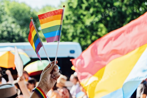Preview: Gay pride, LGBTQ rainbow flags being waved in the air at a pride event. wave LGBTQ gay pride flags