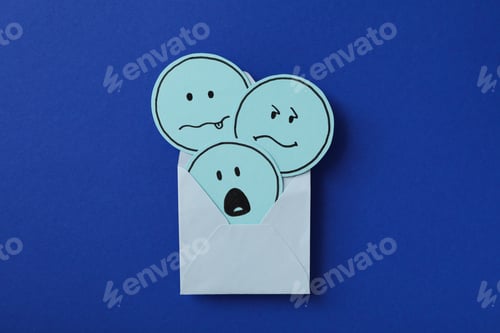 Preview: Envelope with sad emoji on blue background, top view