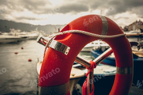 Preview: Toned photo of lifebuoy at rainy weather in seaport