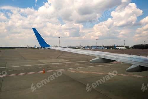 Preview: View of jet airplane wing taxiing runway after landing at airport. Travel and air transportation