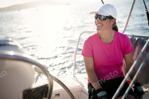 Preview: Happy strong woman sailing with her boat