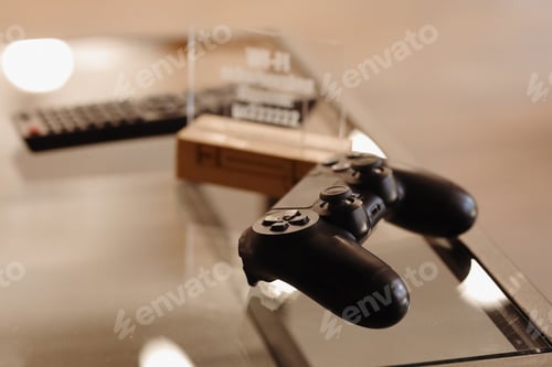 Preview: video game controller on glass table. gaming, technology and entertainment concept - blue gamepad