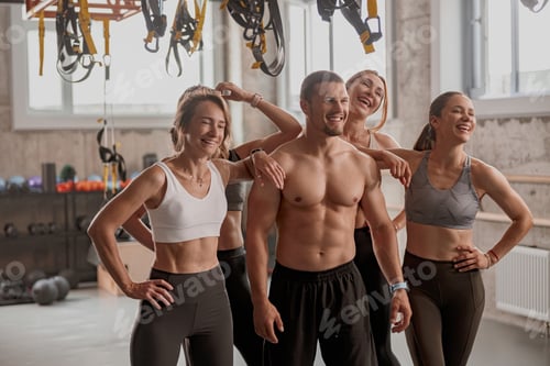 Preview: Personal trainer with his clients in gym