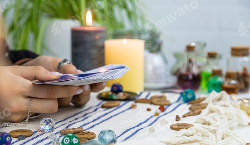 Preview: A fortune teller reads with tarot cards. Selective focus.