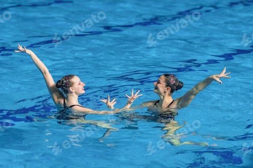 Preview: Performance of a female synchronized swimming duo, their fluid movements and synchronized elegance