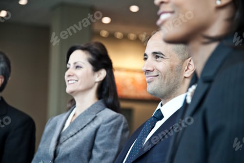 Visualização: Closeup side view of business people in a meeting with the emphasis on a middle eastern businessman.