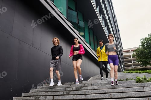 Preview: Sporty young people enjoy an outdoor run on modern city steps in vibrant athletic wear