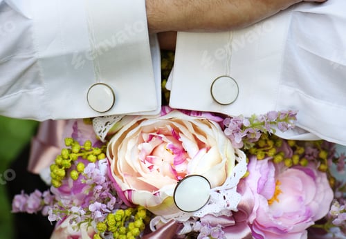 Preview: Groom holding bouquet for bride