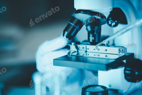 Preview: female medic in uniform working with microscope making analysis at the laboratory, Close-up shot of