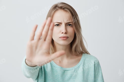 Preview: Body language. Disgusted stressed out angry blonde young female with straight fair hair posing
