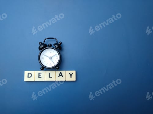 Preview: Black alarm clock with the word DELAY