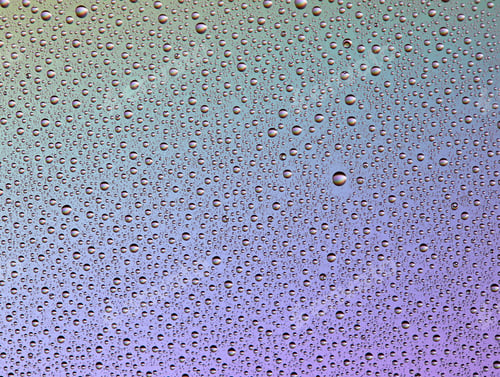 Preview: Drops on glass of different sizes and colors on a colored background, texture