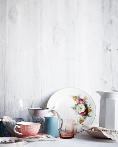Preview: A variety of elegant tableware on a white wooden background.