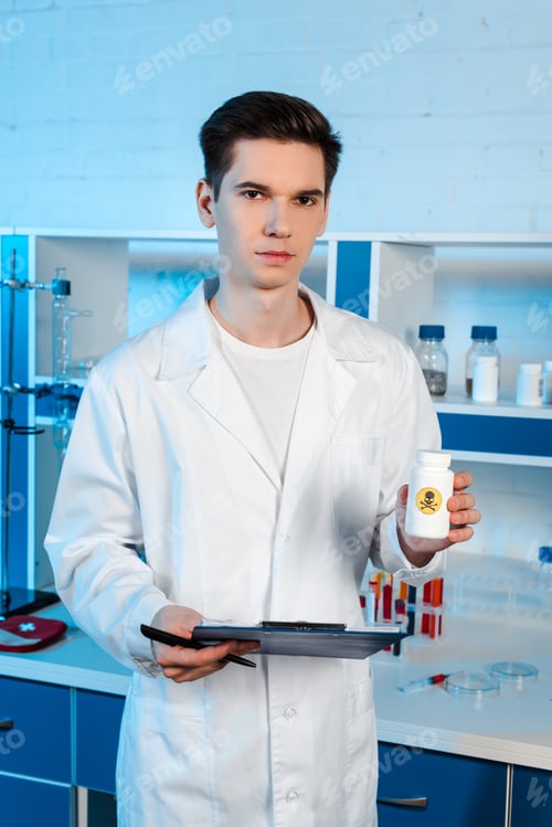 Preview: handsome scientist holding clipboard and bottle with toxic symbol