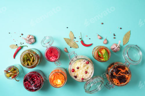 Preview: Assortment of various fermented and marinated food over blue background, copy space. Top view