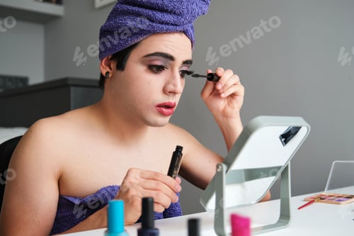 Preview: Young drag queen applying eye mascara.