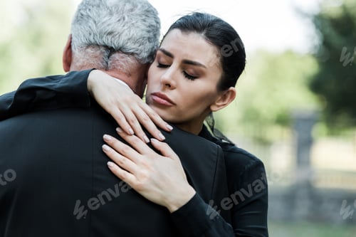 Preview: upset woman with closed eyes hugging senior man