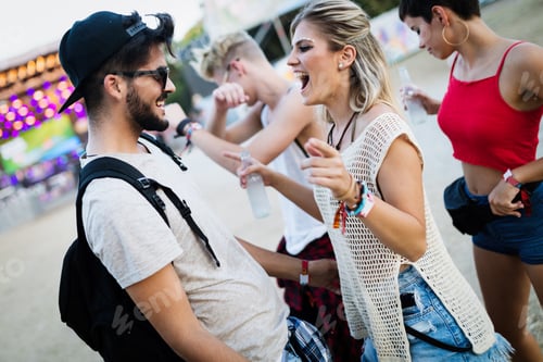 Preview: Happy friends having fun at music festival