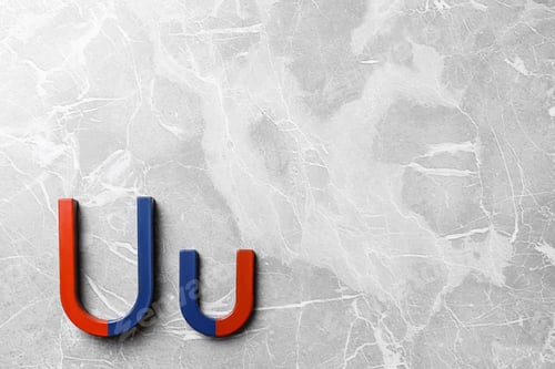 Preview: Red and blue horseshoe magnets on grey marble background, flat lay. Space for text