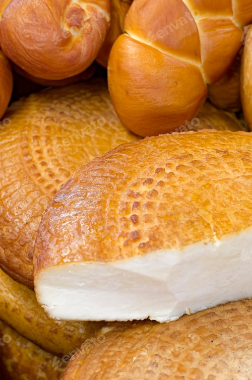 Preview: Assorted traditional homemade smoked cheeses on a market stall