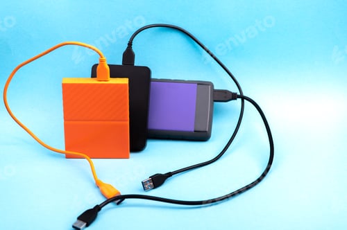 Preview: Three external portable hard disk drives isolated on light blue background