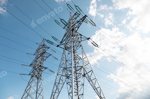 Preview: Bottom view of transmission towers against blue sky