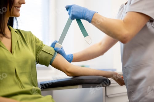 Preview: Nurse takes blood test of a young woman in laboratory